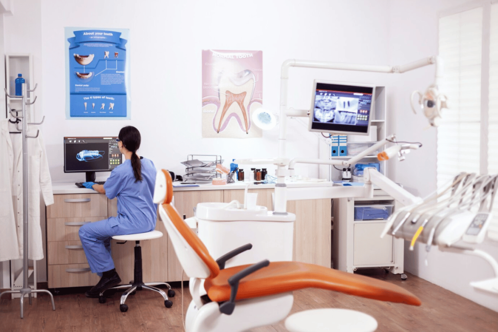 A dental office with a person sitting at a desk.