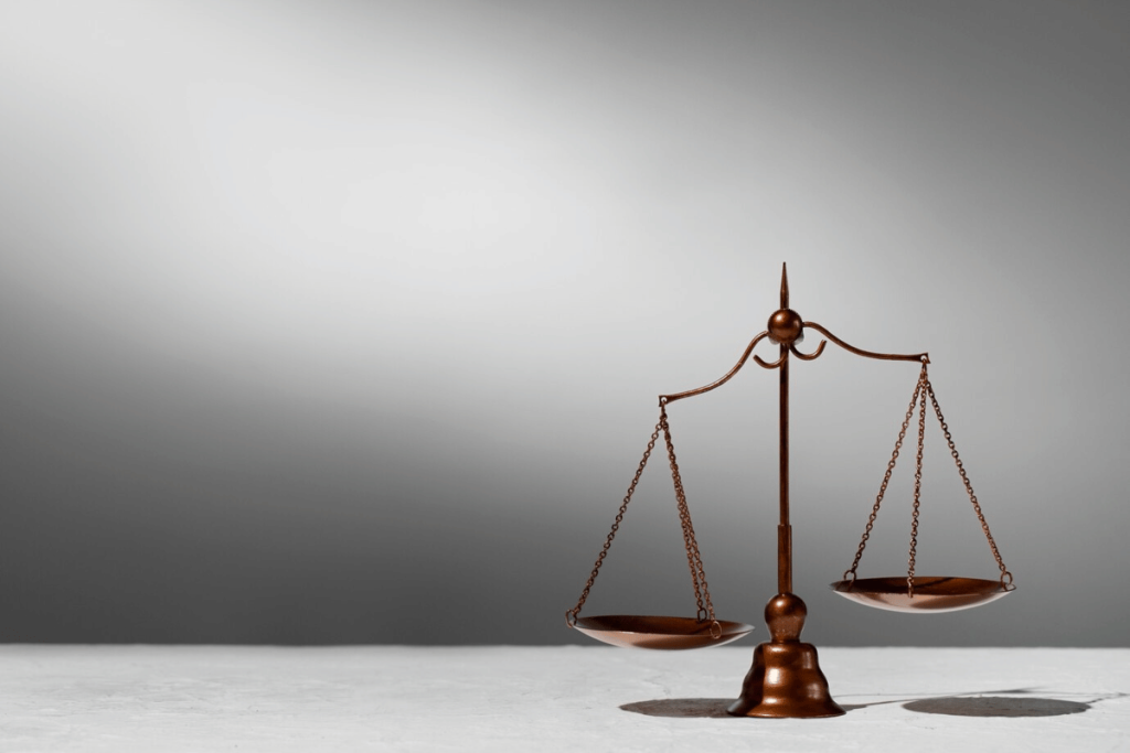 An image of a justice scale on a table.