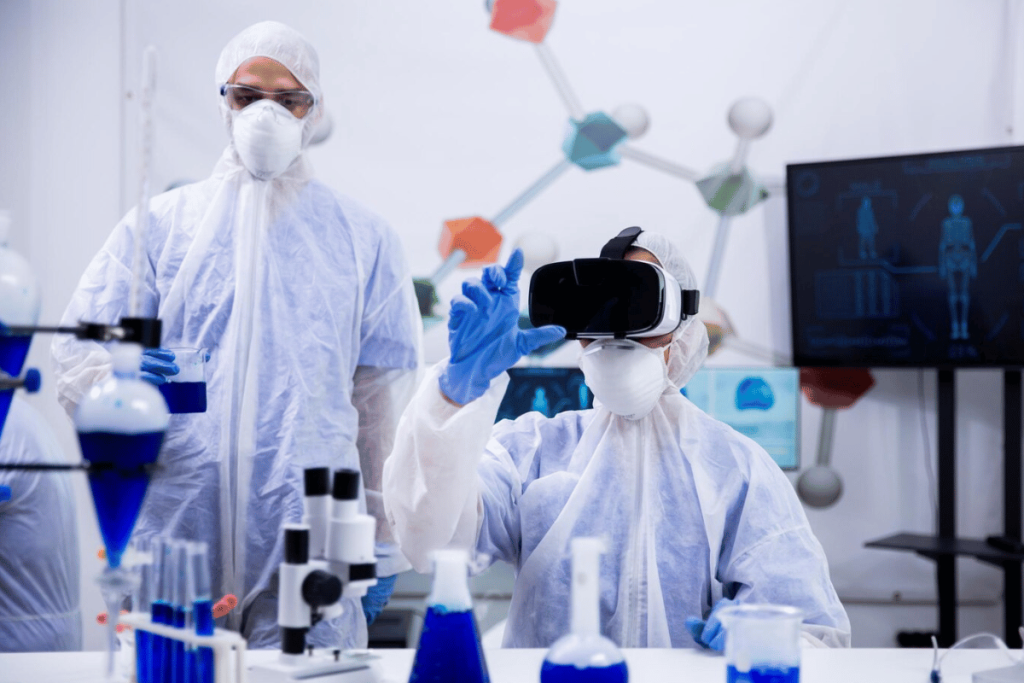 Two people in lab coats wearing virtual reality glasses.