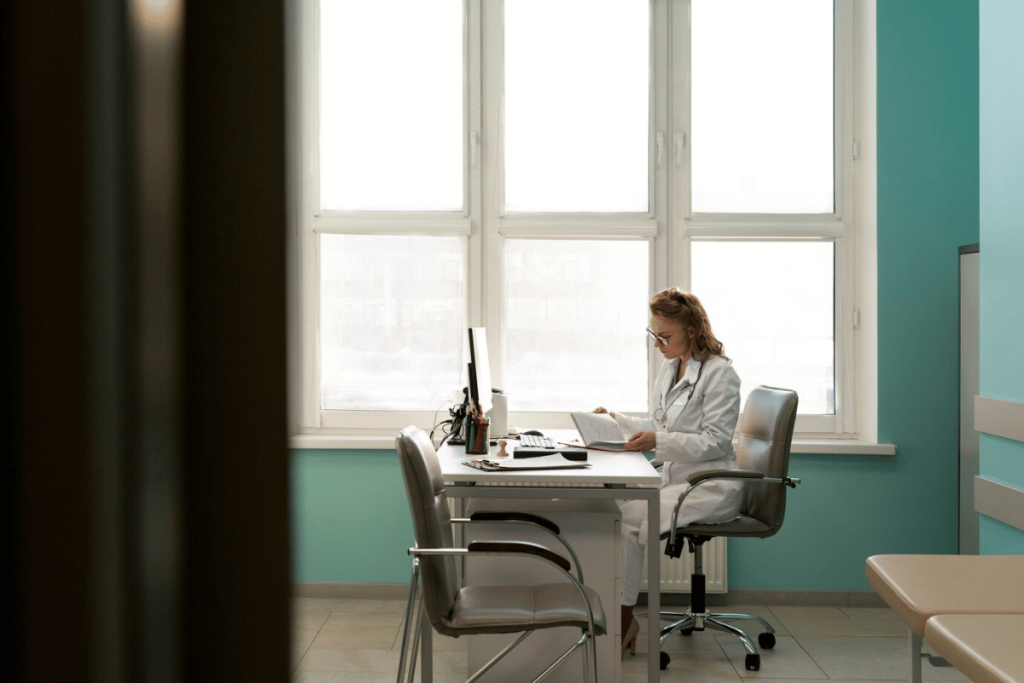 A doctor sitting at a desk in an office.